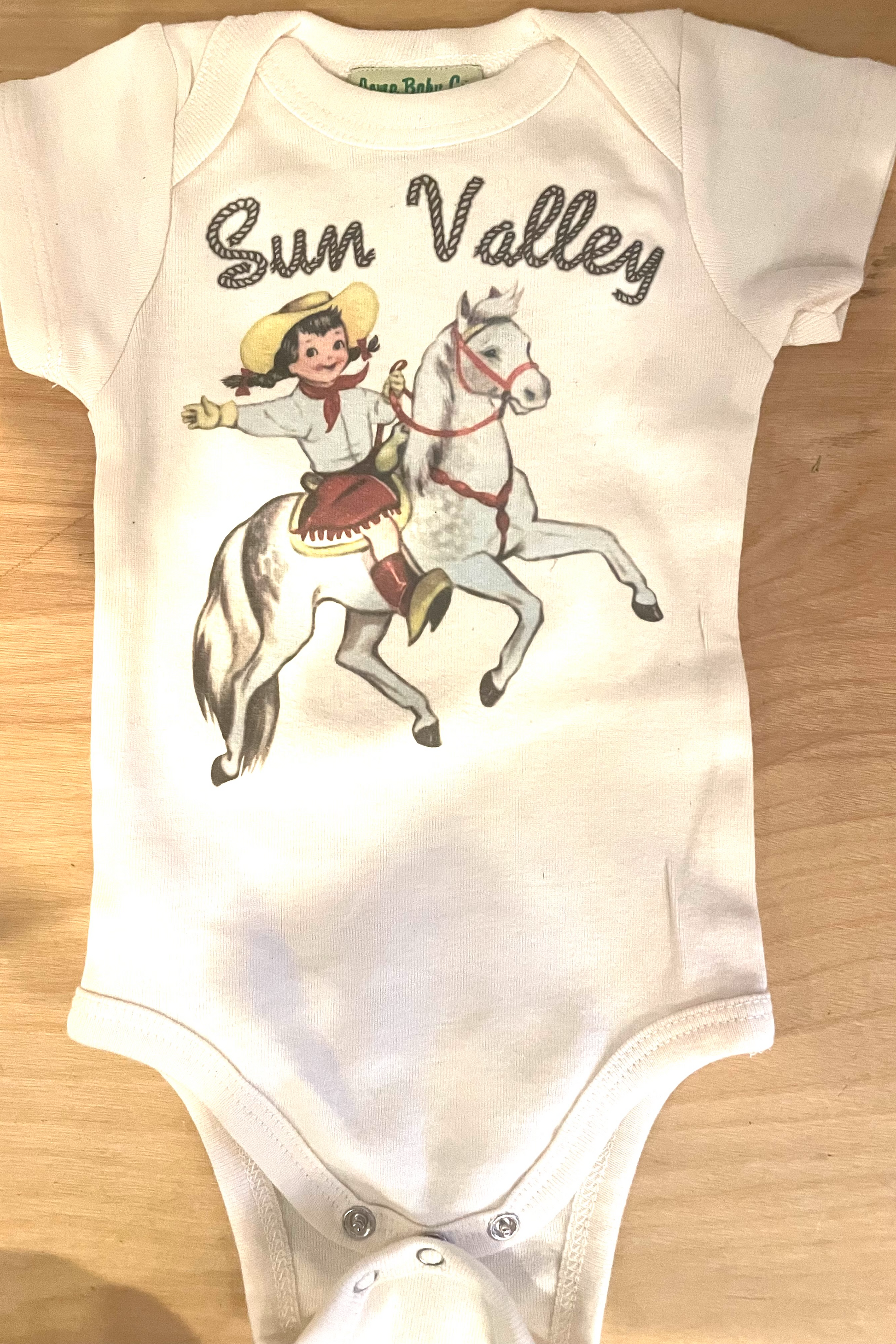 Sun Valley Cowgirl Organic Cotton Bodysuit - Sun Valley signature