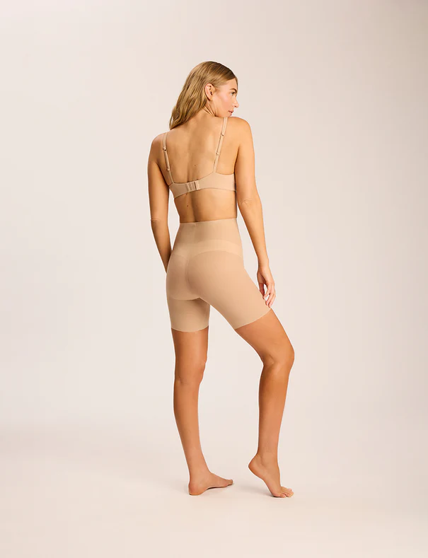 Model wearing the Commando Featherlight Control Short in Beige, back view